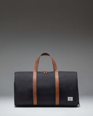 Herschel Novel Duffle bag in classic black, showing a side view highlighting its clean design and signature shoe compartment.