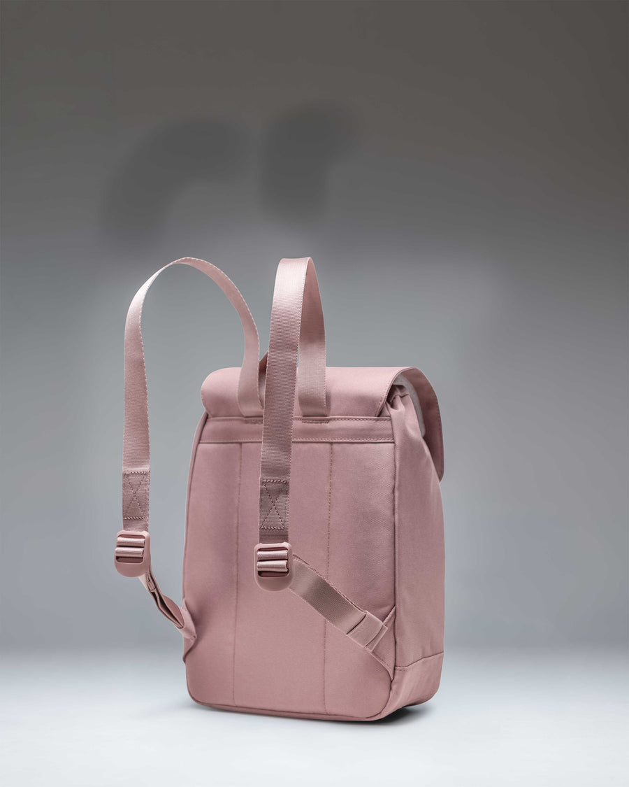 Herschel Retreat Mini Backpack in Ash Rose featuring magnetic strap closures, a drawcord main compartment, and a front storage sleeve.