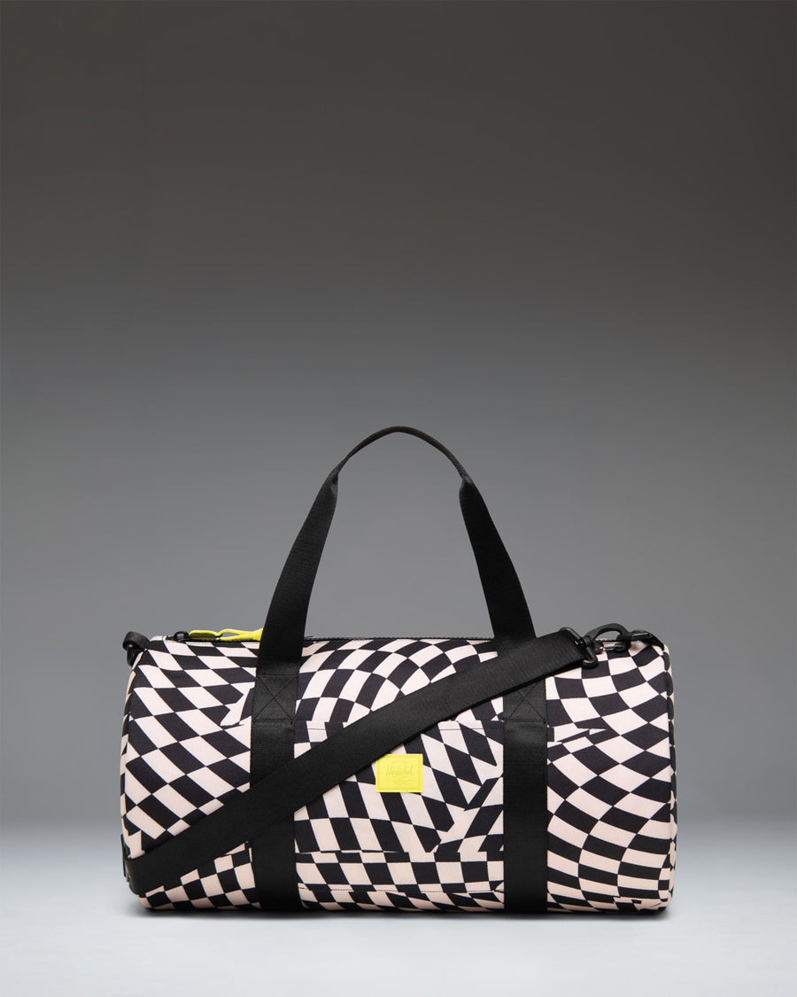 Herschel Supply Co. Classic Duffle Little Herschel in Warp Check pattern, a kid-sized travel bag with black and white checkered print.