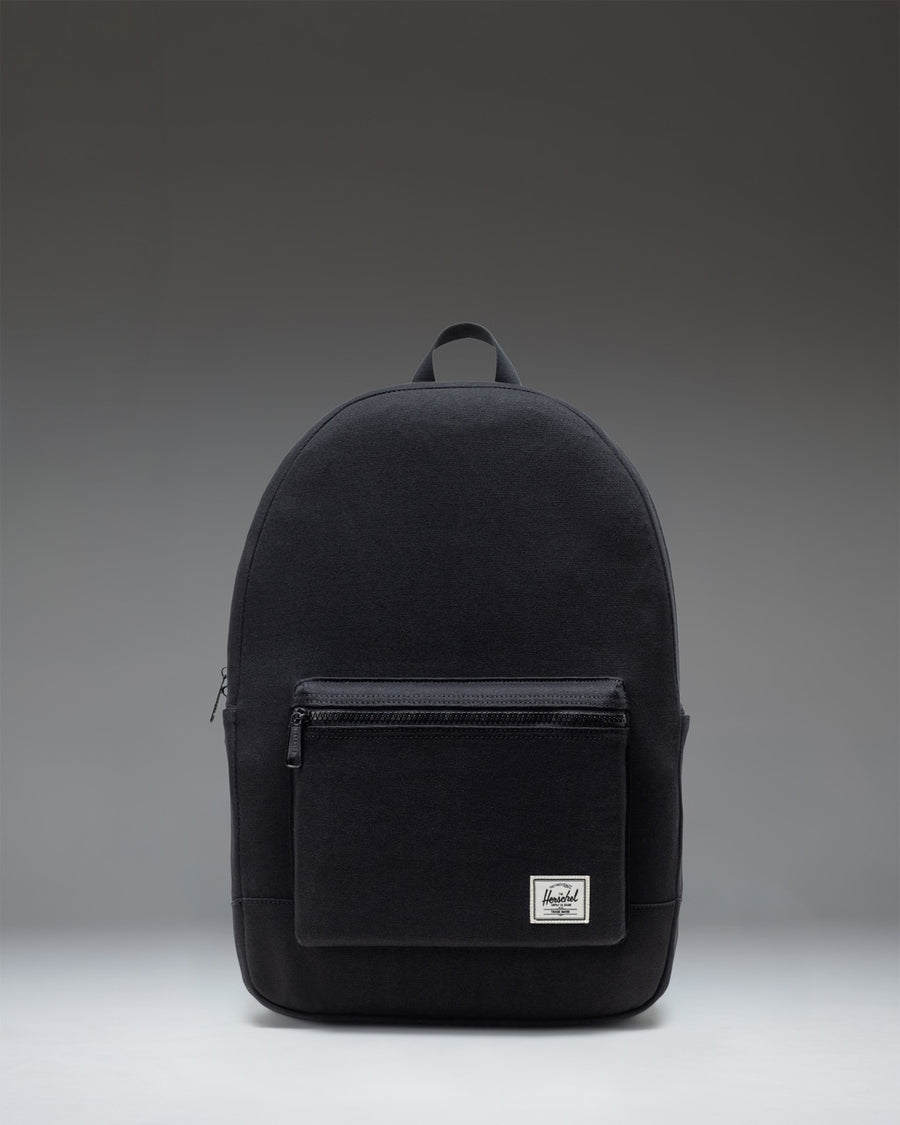 Front view of the Herschel Supply Co. Pacific Daypack in black, featuring a clean, classic backpack design with zippered compartments.