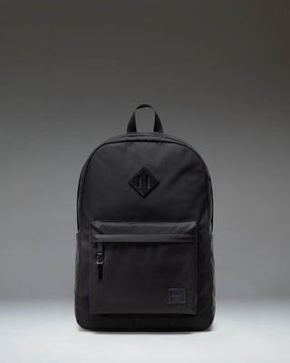 Herschel Heritage Backpack in Black featuring a classic design with a front storage pocket and signature woven label.