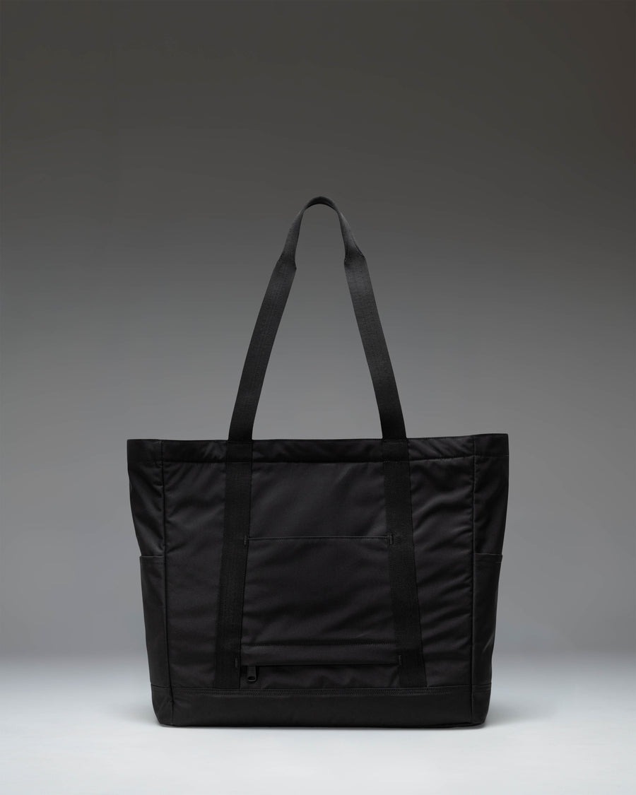 Herschel Heritage Tote bag in classic black recycled polyester construction featuring top-carrying handles and a front zip pocket with a key clip.