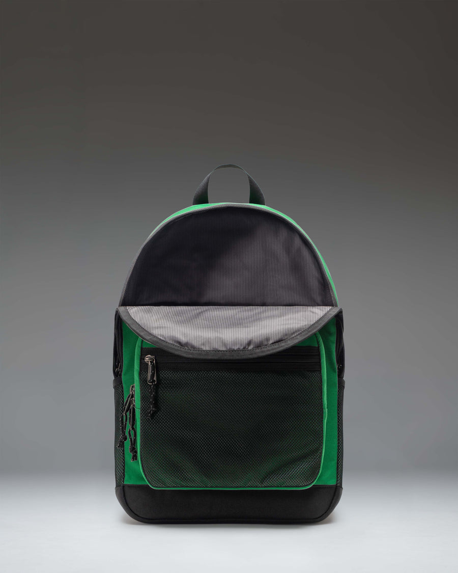 Herschel Supply Co. Kaine Backpack in Varsity Pine green, showing a detailed close-up of the front zippered pockets and durable design.