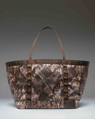 Herschel Supply Co. Realtree All Season Gear Tote 63 L in Realtree APX Camo pattern, showing a spacious design perfect for outdoor gear.