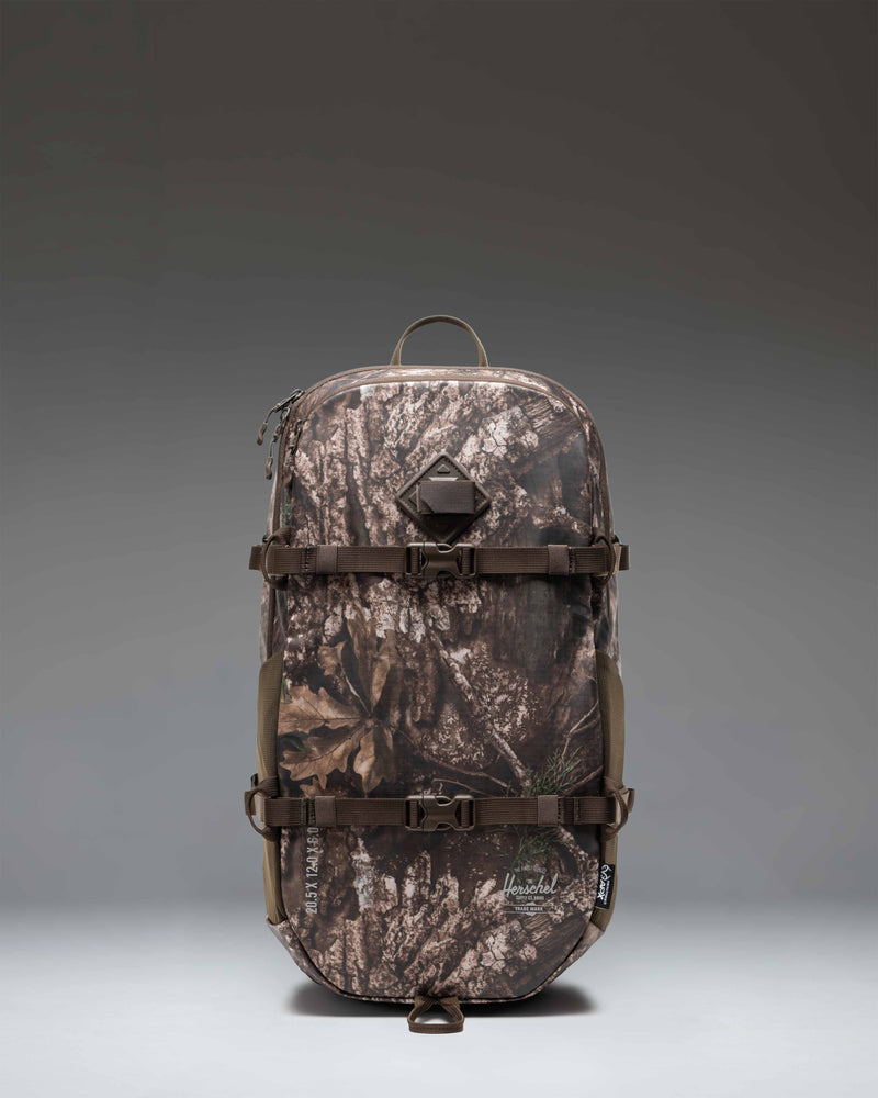 Herschel Supply Co. Realtree All Season Backpack 29 L in Realtree APX Camo pattern, showing the front view with straps and pockets.