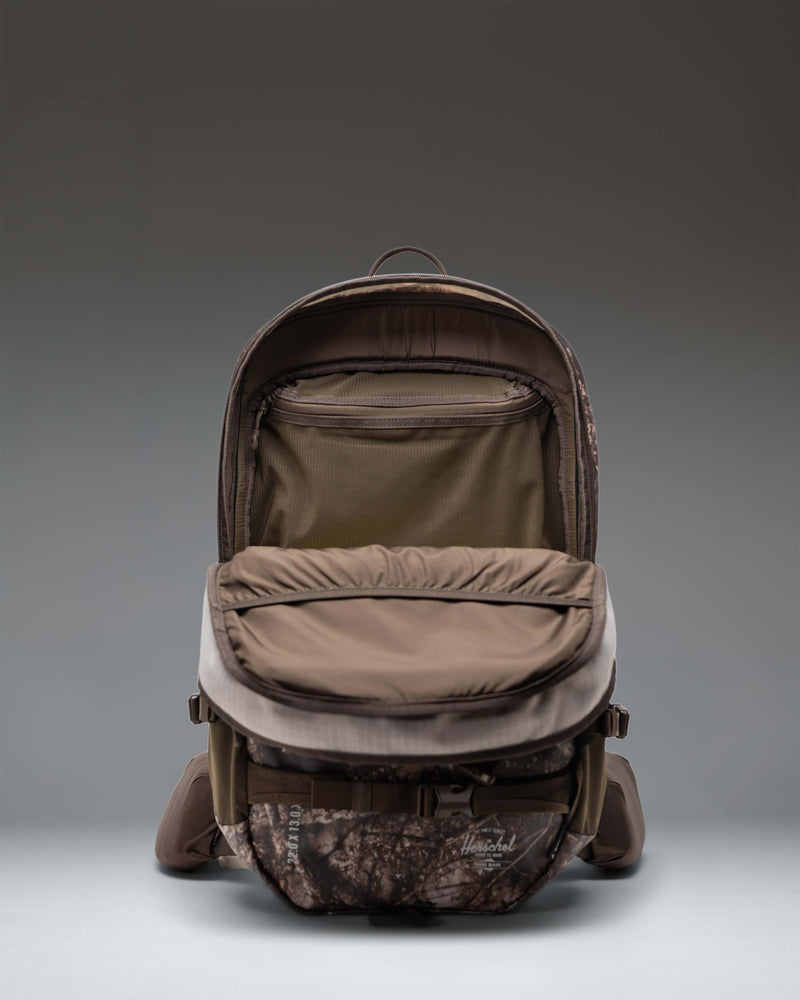 Herschel Supply Co. Realtree All Season Pro Backpack 36L in Realtree APX Camo, showing features and pocket details.