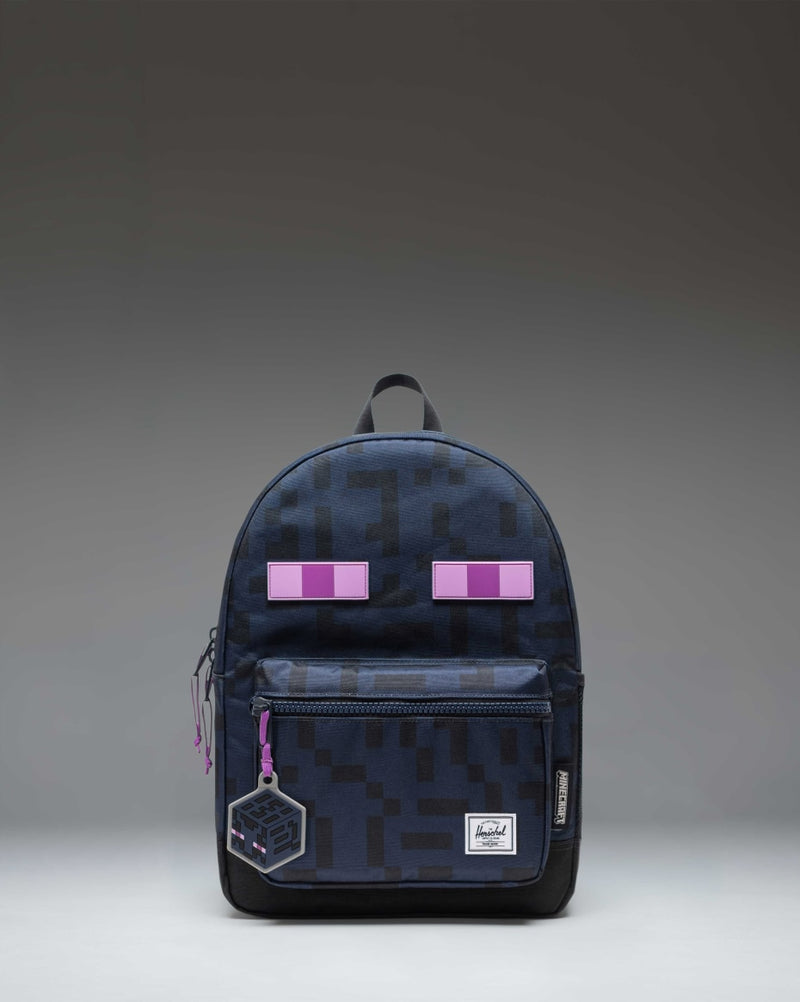 Minecraft Herschel Heritage Kids Backpack in Enderman black and purple print, featuring a pixelated character design and a front storage pocket.