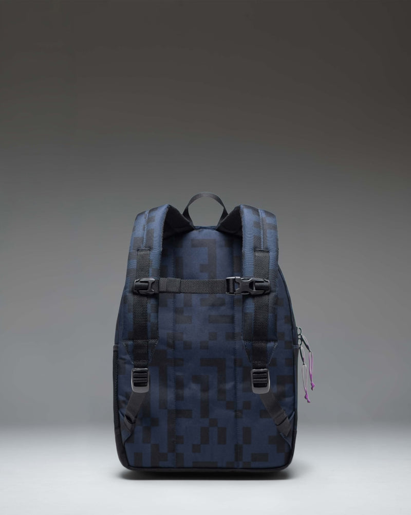 Herschel Supply Co. Minecraft Heritage Kids Backpack in the Enderman design, featuring a pixelated purple pattern and character details.
