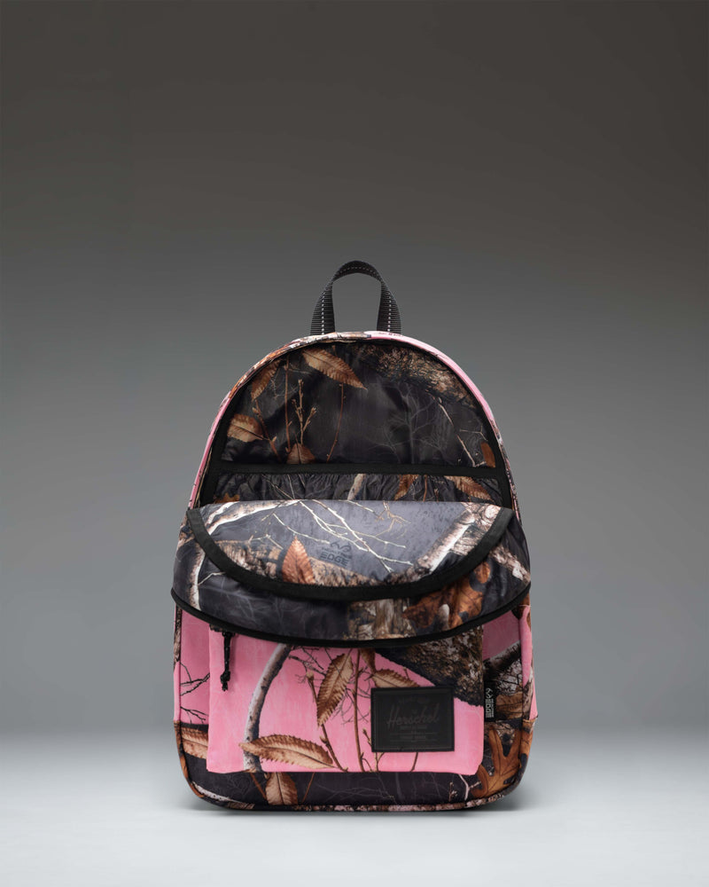 Herschel Supply Co. Classic Backpack in Realtree Edge Camo Pink/Black featuring a vibrant pink and black camouflage pattern.