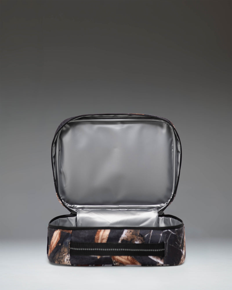 Herschel Supply Co. Realtree Pop Quiz Lunch Box in Realtree Edge Camo White/Black, showing an open main compartment view.