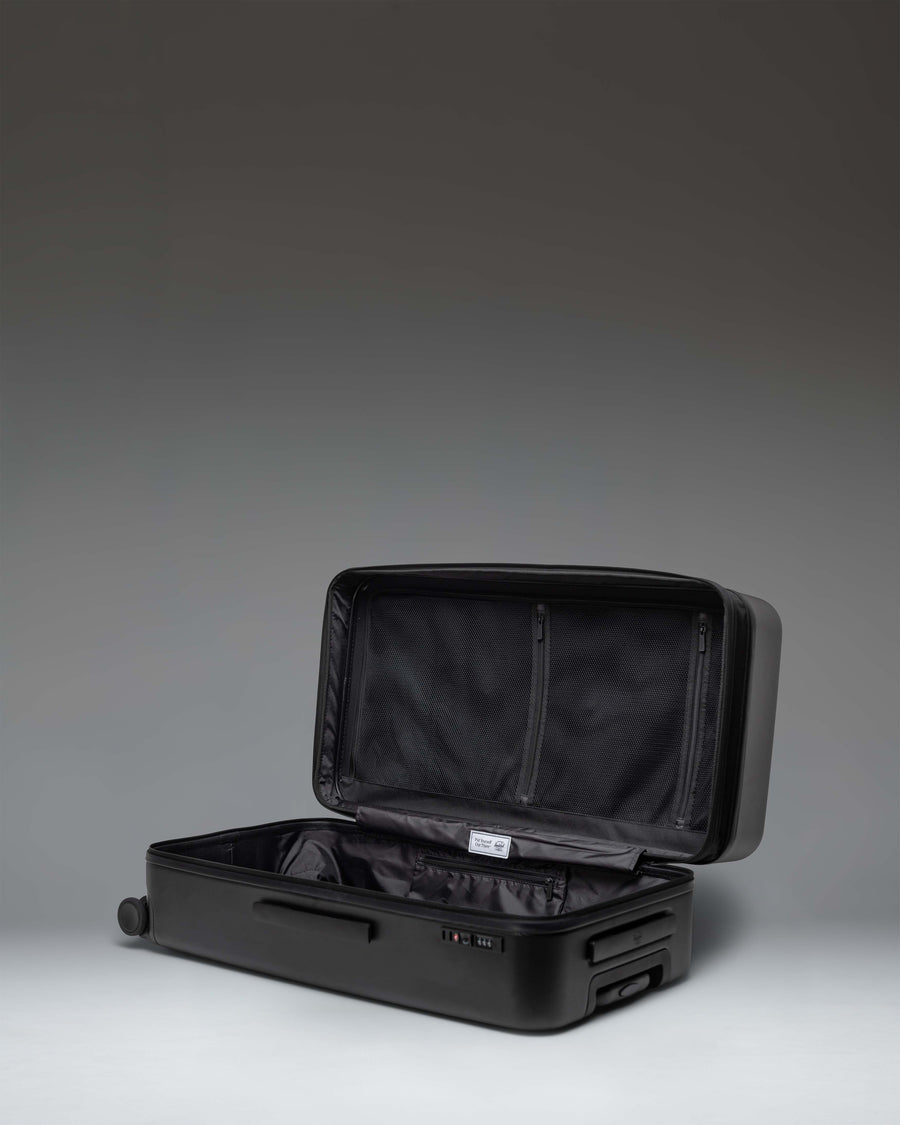 Herschel Heritage Hardshell Large Luggage Exp in Black, showing a durable expandable exterior design.