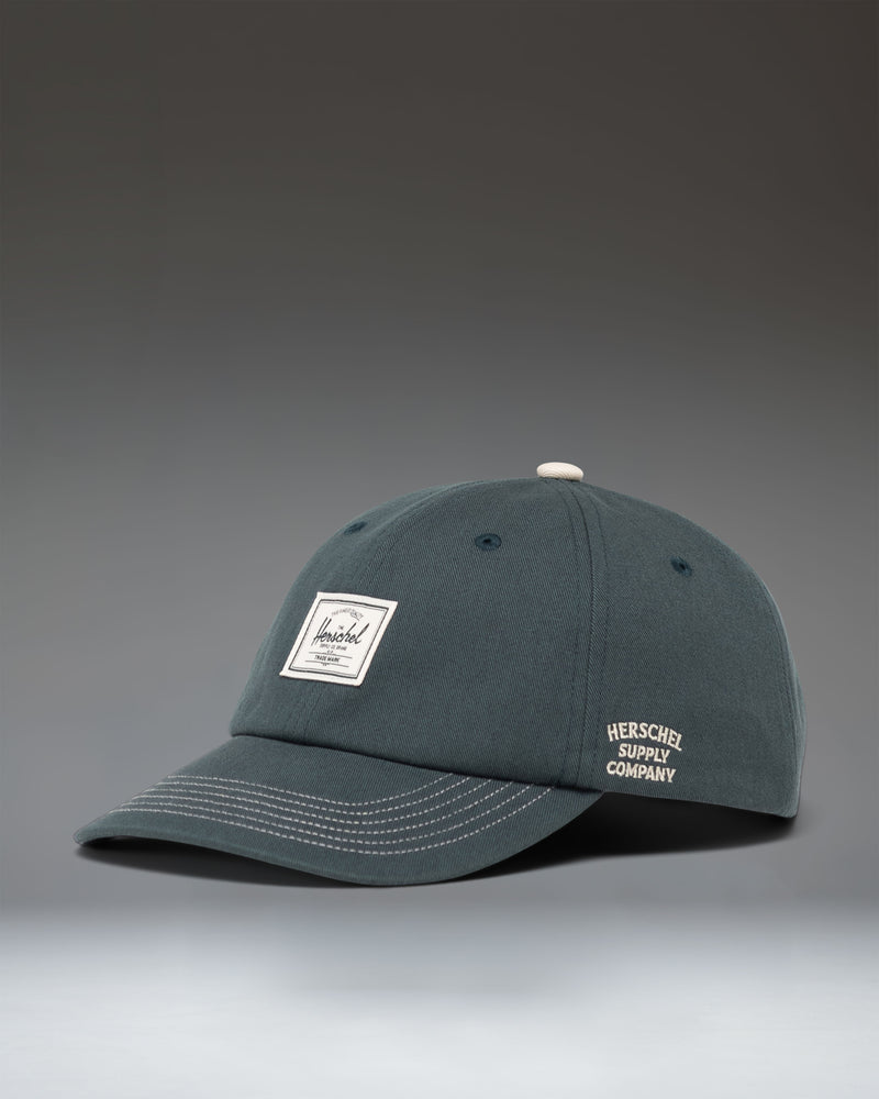Herschel Supply Co Sylas Premium Cap in Green Gables dark green with vintage white stitching.