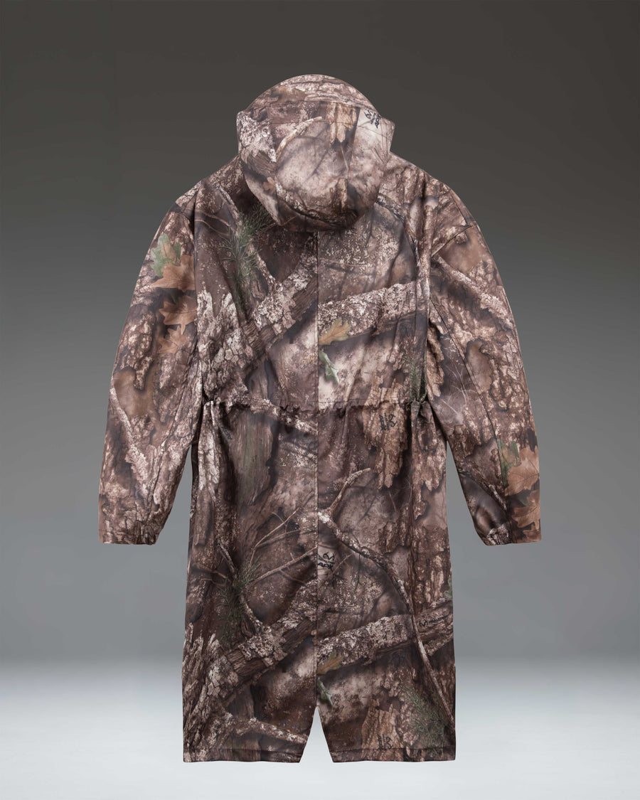Herschel Supply Co. Realtree Skeena raincoat for women in a brown and green leafy APX camouflage pattern.
