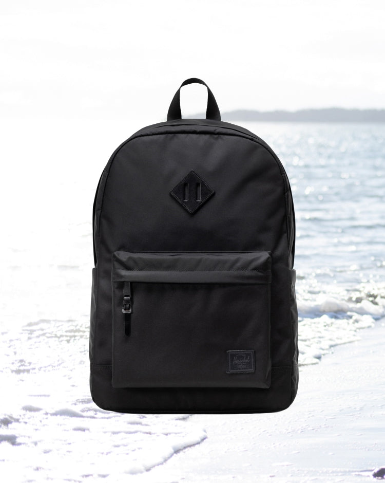 Herschel Supply Co. Heritage Backpack in classic black, showing a clean front view with the signature woven label.