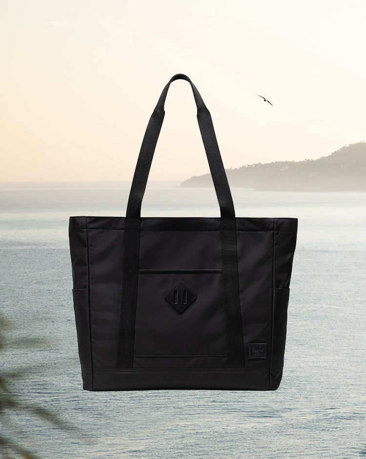 Black Herschel Heritage Tote bag featuring a classic design with dual top handles.