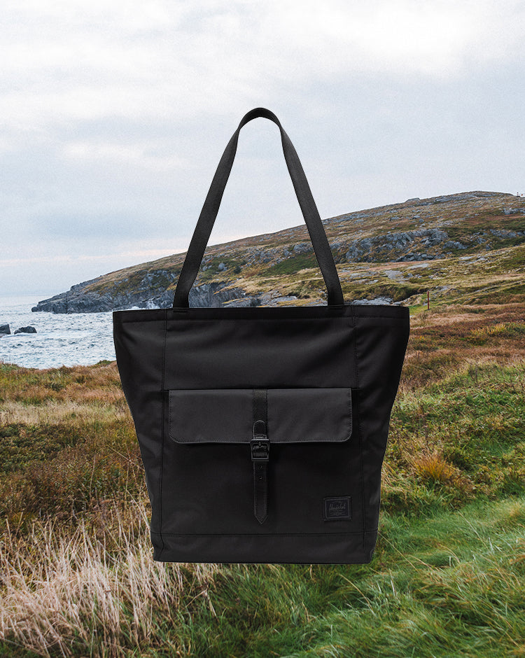 Black Herschel Retreat Tote bag shown from the front against a plain background.
