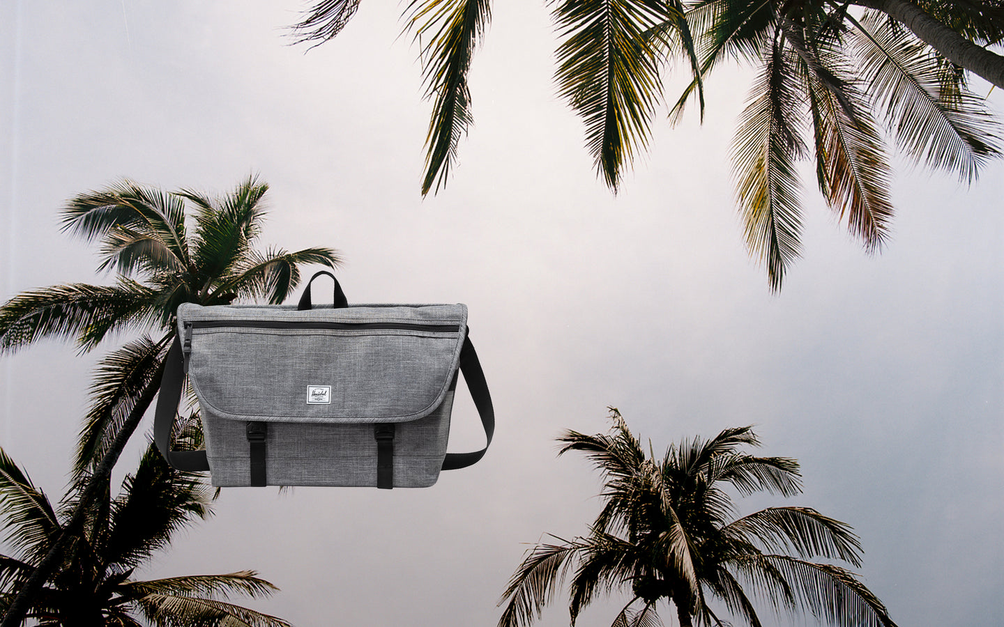 Herschel Supply Co. Cove Messenger bag in Raven Crosshatch grey, displayed as a hero banner image for desktop view.