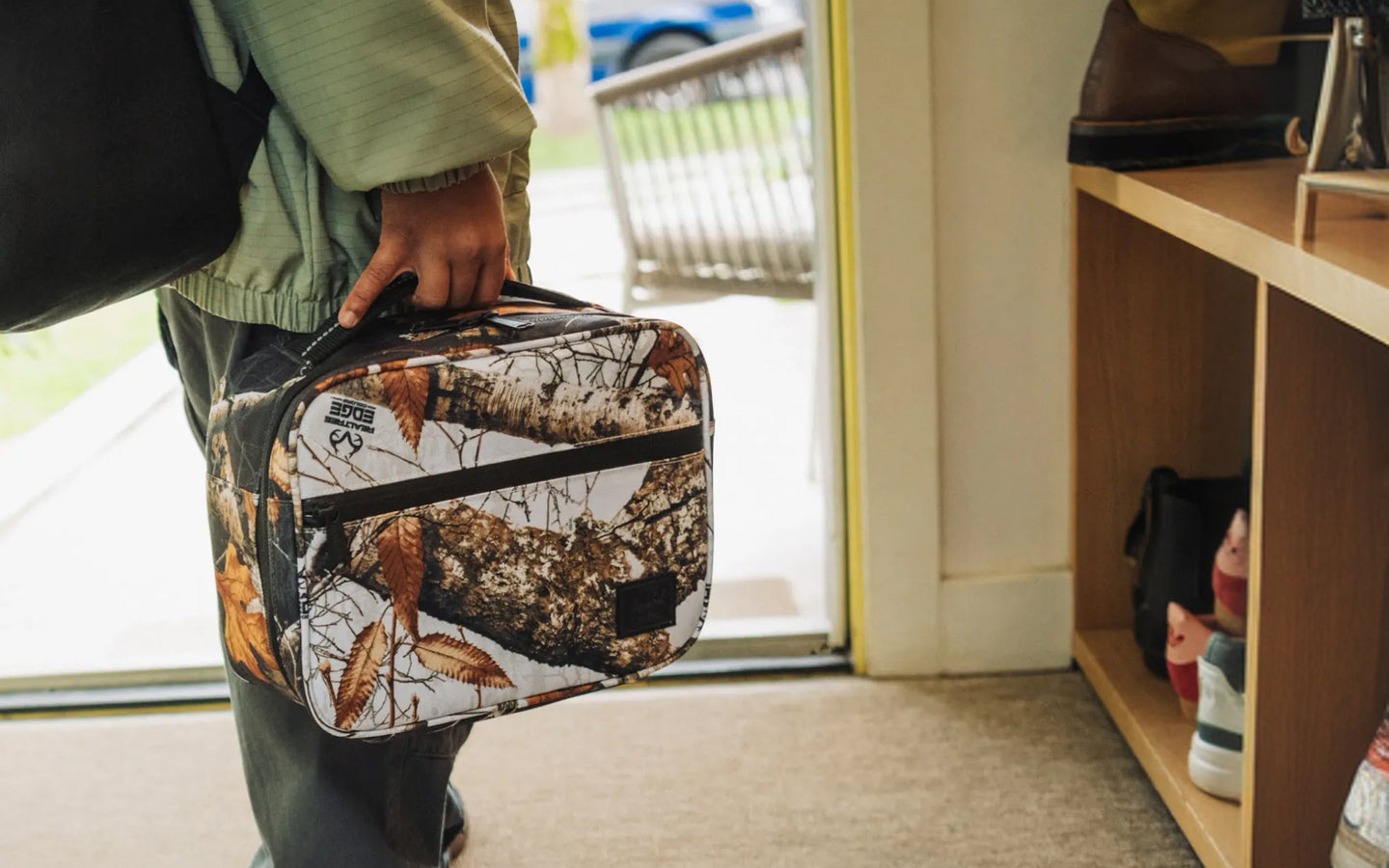 Herschel Supply Co. Realtree Pop Quiz Lunch Box in the black and white Realtree Edge Camo pattern.